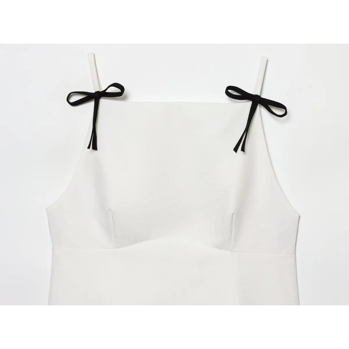 Partial front view showing the square neckline and both black bow straps