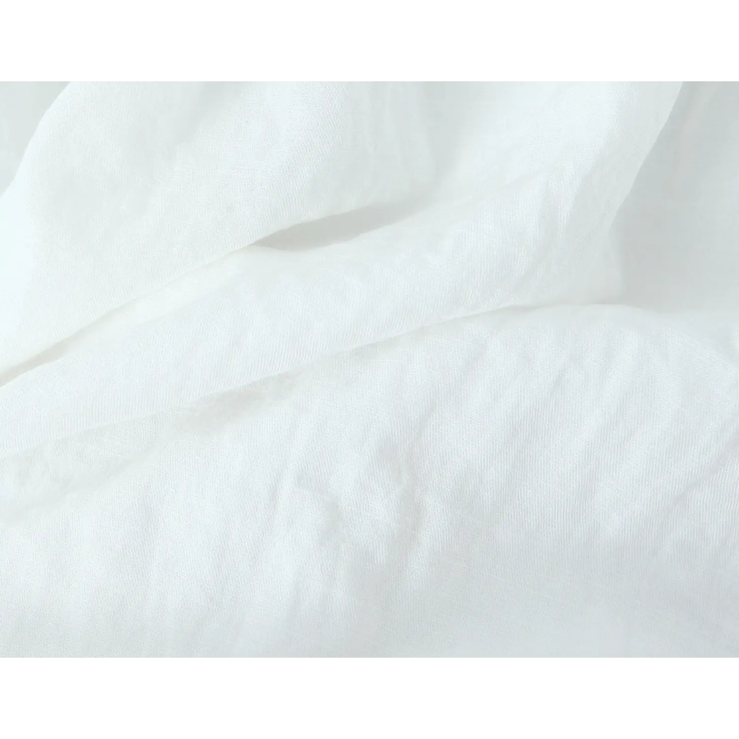 Macro close-up of folded soft white textured fabric for summer lace camisole tank top