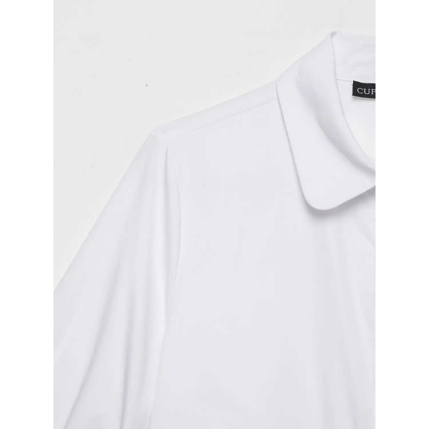Close up shoulder fabric detail of white pearl trimmed collared blouse