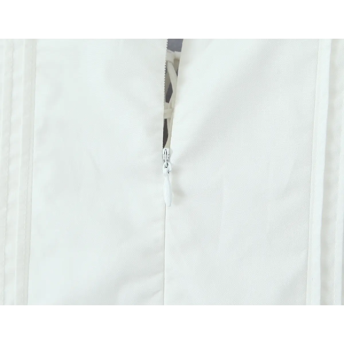 Close-up of the side zipper and fabric construction on the white corset dress.