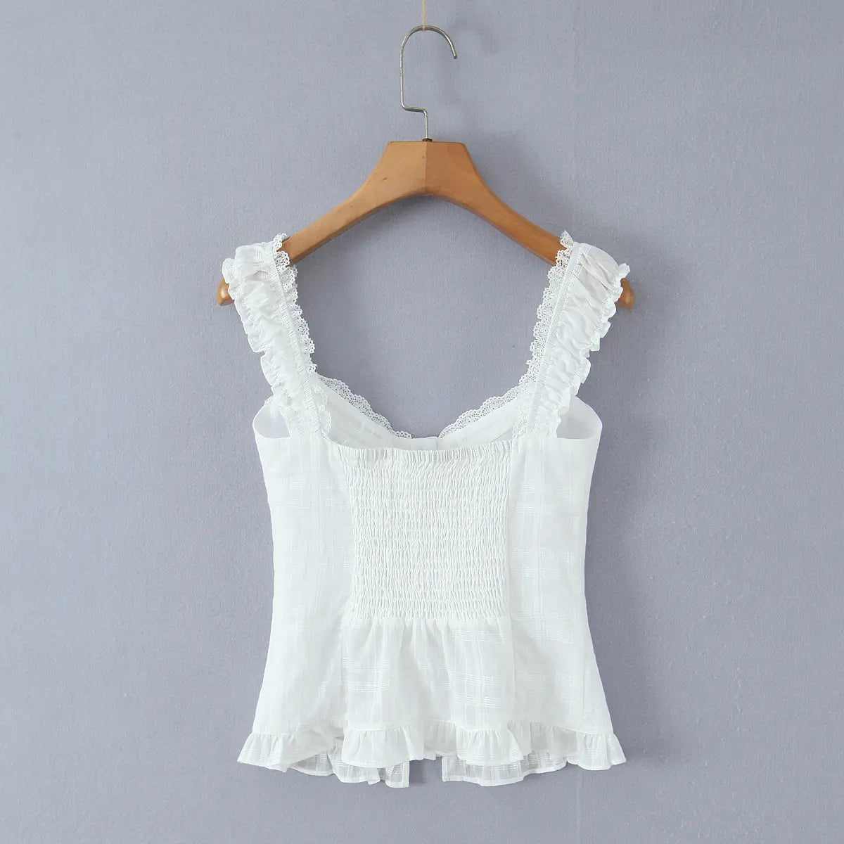 Full back view of the top, showcasing the smocked panel and ruffled hem.