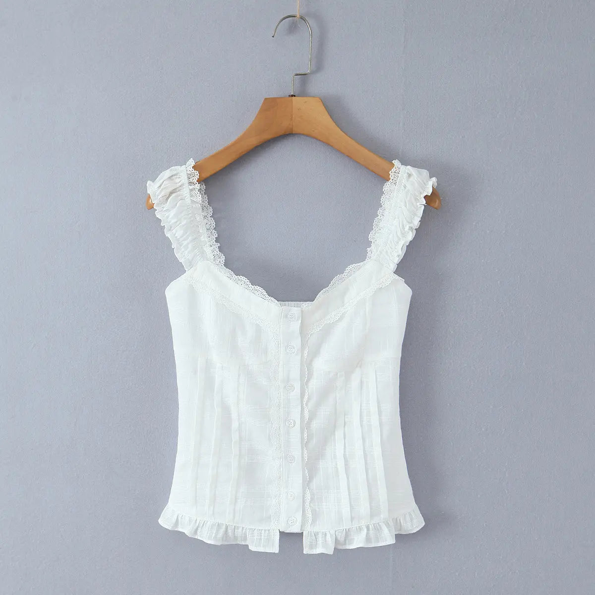  Full front view of the top, showing the sweetheart neckline, button placket, lace trim, and ruffled hem.
