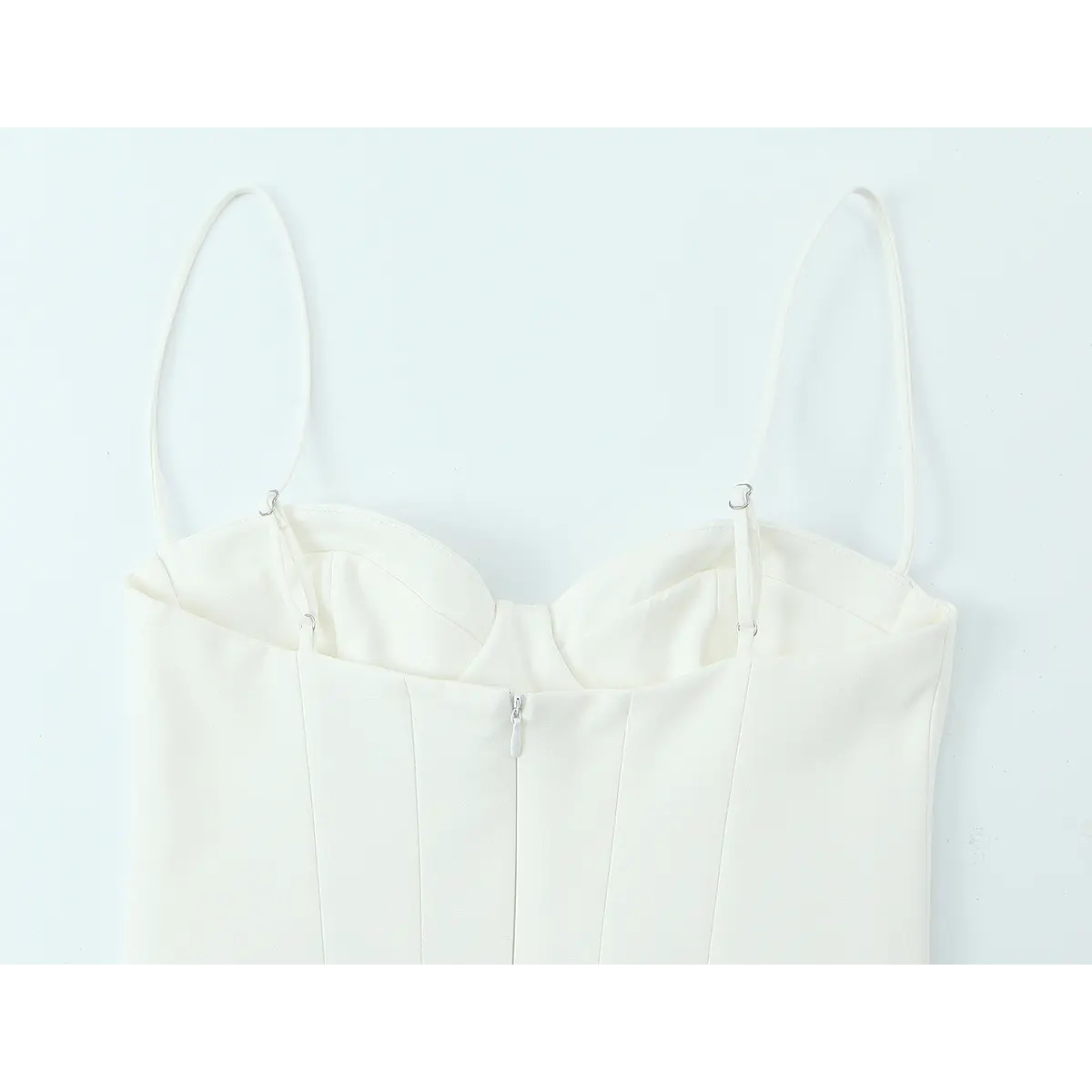 Back view of the white crepe cami dress, showing the center back zipper, adjustable straps, and structured bodice