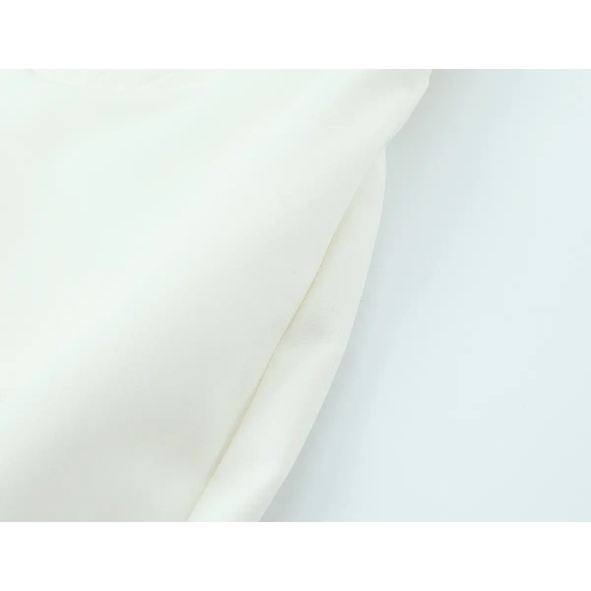 Close-up of the dress side seam, showing the smooth crepe fabric and structured fit