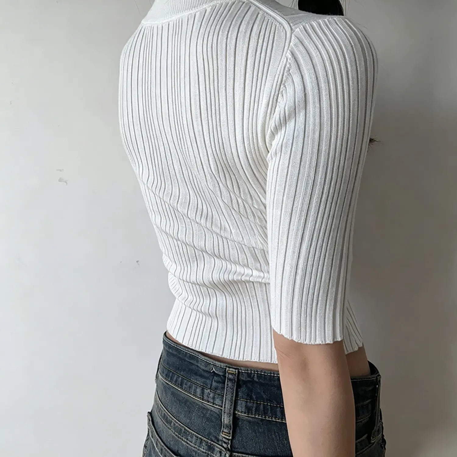 Model back view, white crew neck mid sleeve ribbed knit crop top, vertical rib knit fabric