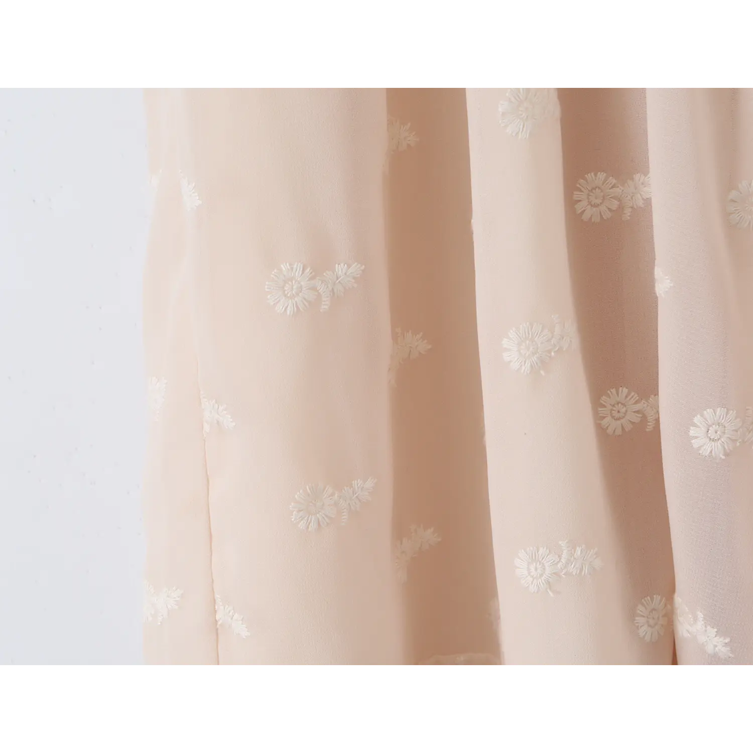 Semi-sheer tulle with 3D white daisy embroidery macro flat close-up, lightweight drape chiffon mesh floral embroidery spring fairy dress fabric detail shot