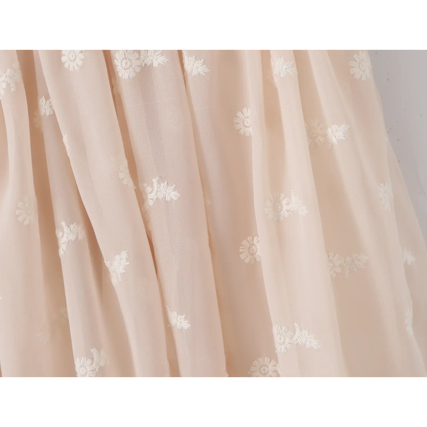 White daisy 3D embroidered sheer tulle fabric macro flat close-up, semi-sheer lightweight mesh floral embroidery spring summer fairy cloth shot