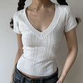 White deep v neck cable twist knit short sleeve cropped top, slim fitted rib hem women casual knit tee studio front view