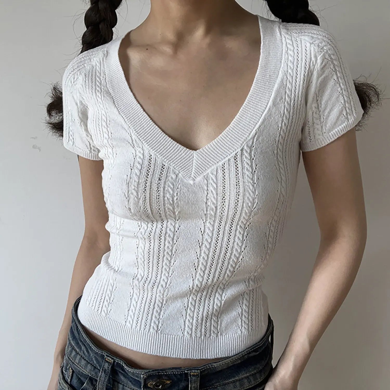 White deep v neck cable twist knit short sleeve cropped top, slim fitted rib hem women casual knit tee studio front view