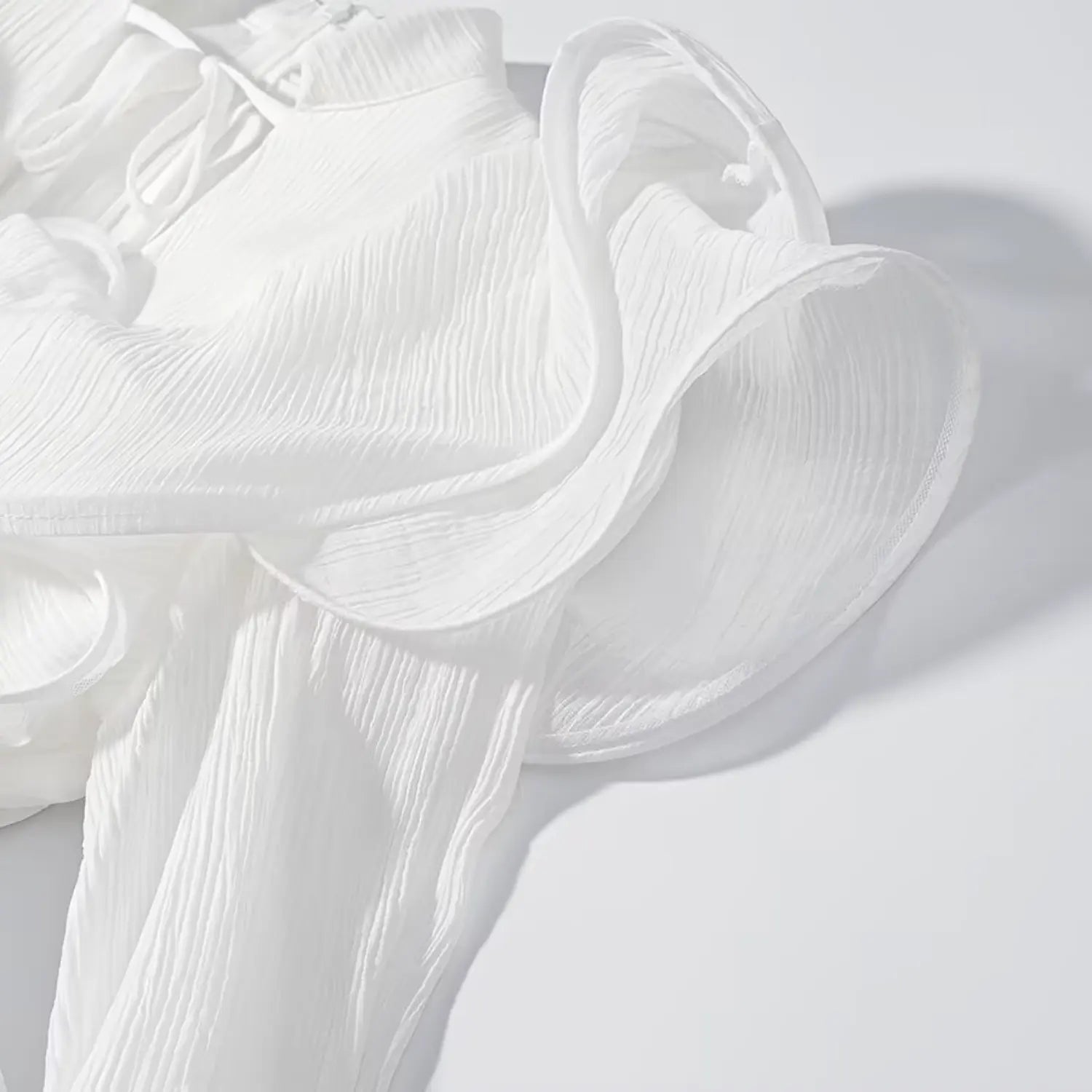 Extreme close-up of 3D layered flower applique and crinkled textured fabric
