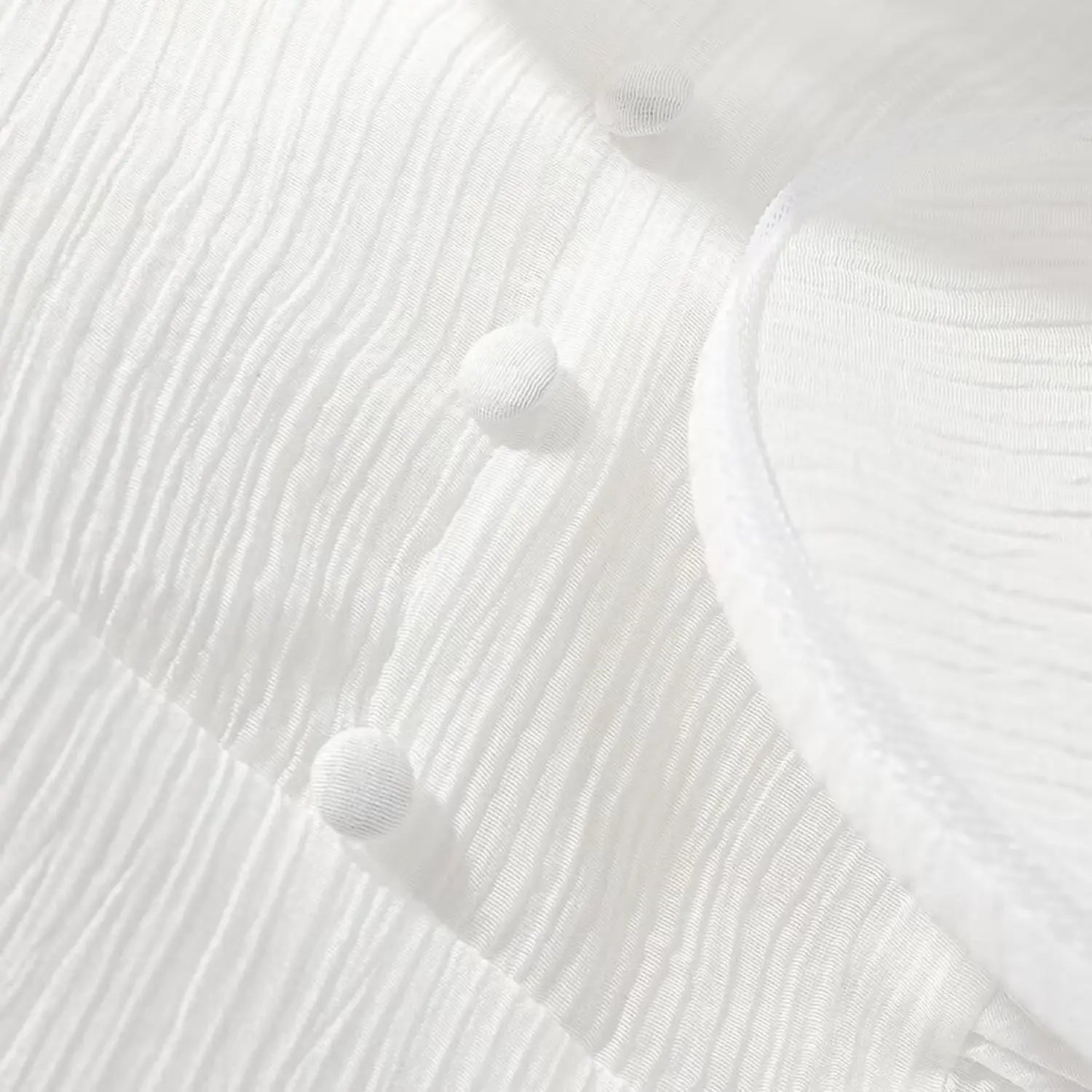 Macro close-up of fabric texture and round fabric covered buttons on white mini dress
