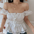 Square-neck lifestyle shot of model wearing the white embroidered peplum top