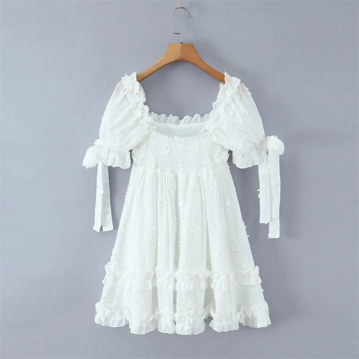Full back view of the dress, highlighting the elastic smocked back panel and tiered skirt.