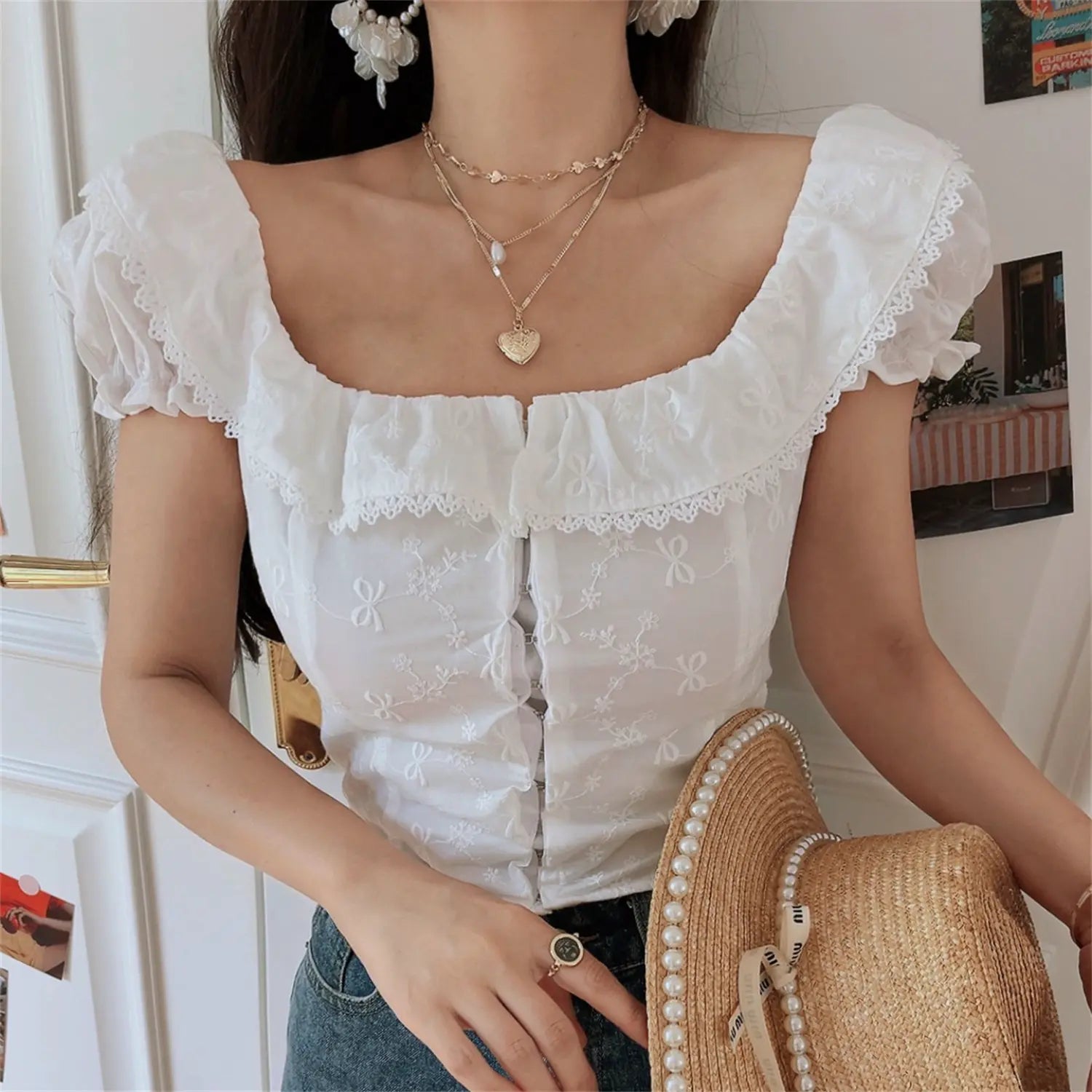 Front view lifestyle shot of the white embroidered square-neck camisole
