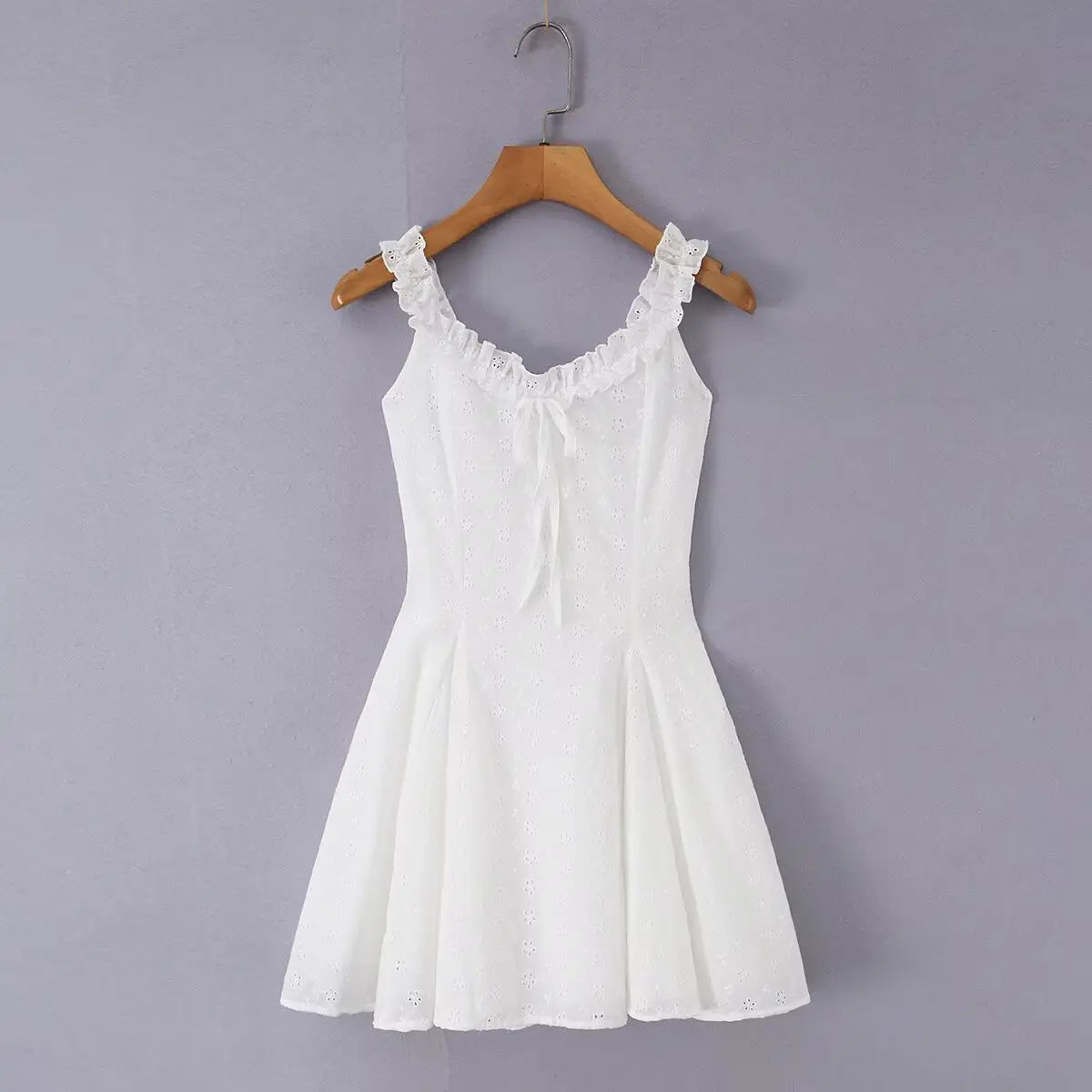 White eyelet embroidered cami skater dress hanging on wooden hanger, front view
