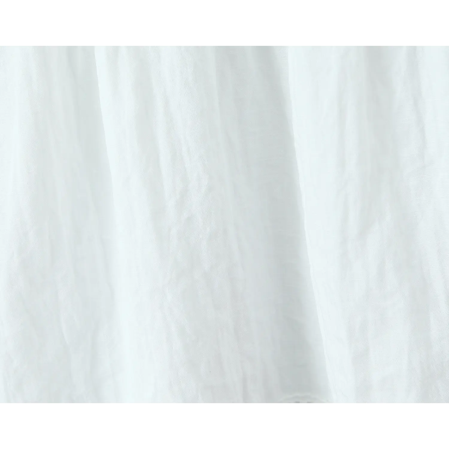 Close-up texture shot of wrinkled white lightweight fabric from eyelet lace camisole top
