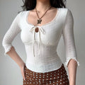 Model front pose hand on hip white eyelet lace 3/4 sleeve top with lace trim neckline and ruffle sleeve hem