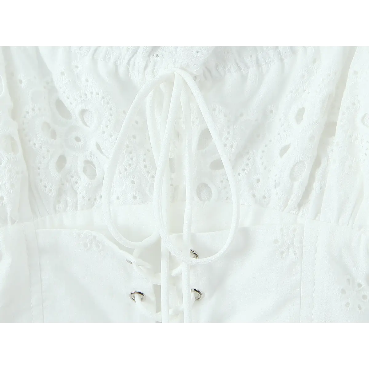 Close-up of corset-style lace-up closure with metal eyelets and drawstring ties.