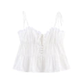 Full front view on white background of the white eyelet embroidered peplum cami top with tie straps