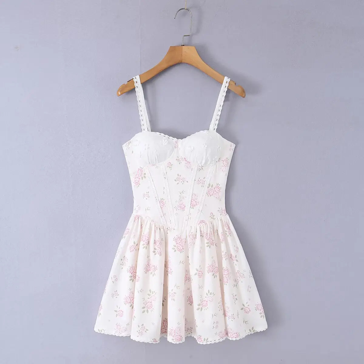 White floral print bustier cami dress hanging on wooden hanger, front view