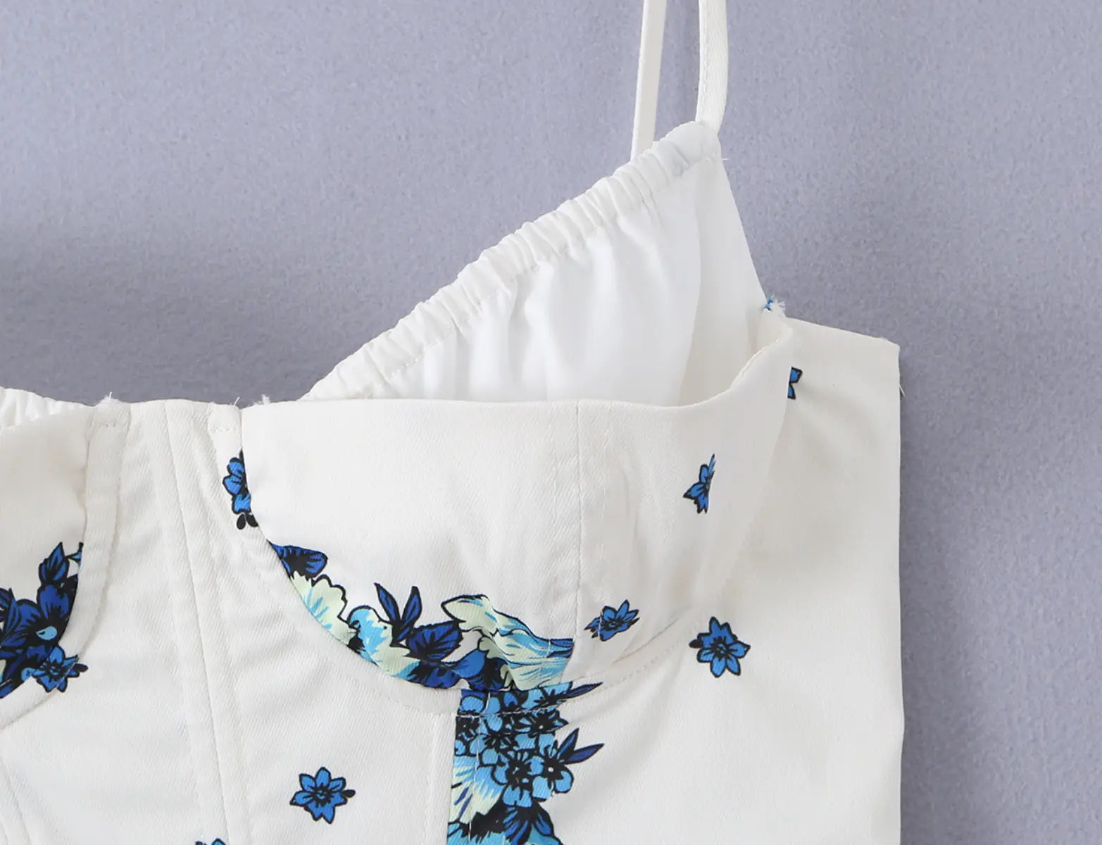 Close-up of the sweetheart neckline and floral print on the corset-style cami top