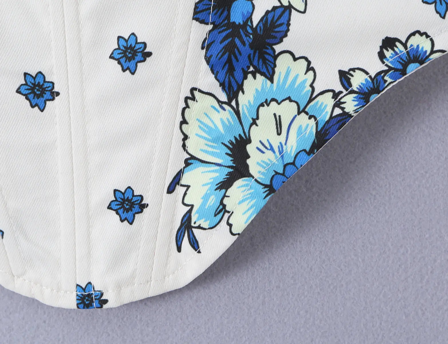Close-up of the blue floral print and fabric texture on the white cami top