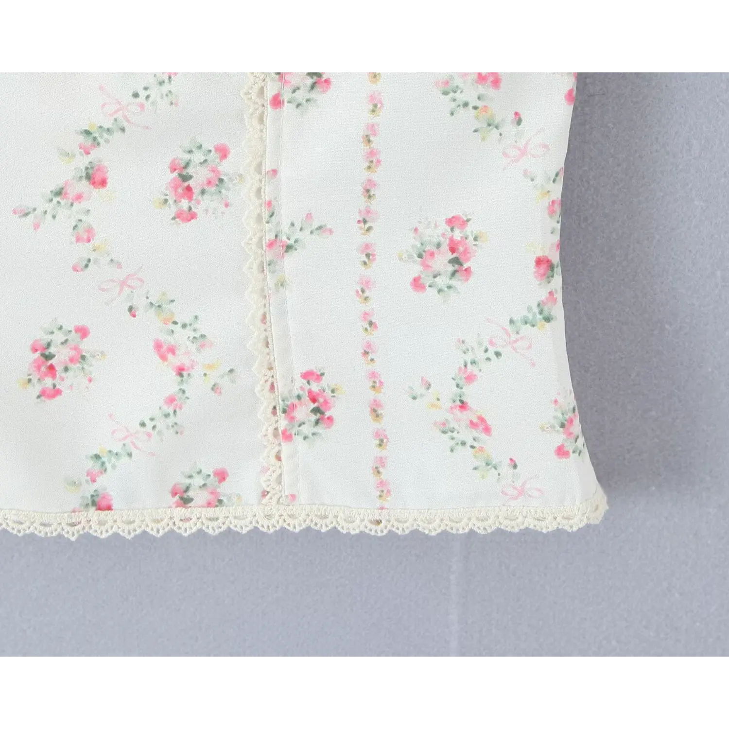 Bottom hem close‑up vertical pink floral print delicate scalloped lace hem edge corset cami top