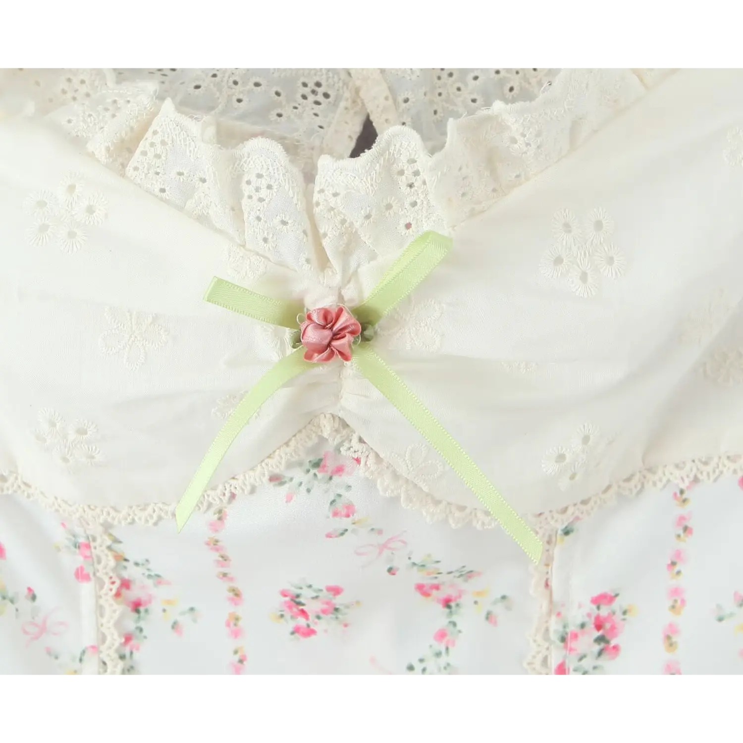 Macro close‑up front green satin ribbon and 3d fabric rose applique on ruched bust