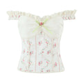 Studio white background product shot white floral corset cami top eyelet lace ruffle straps green ribbon fabric rose bust detail