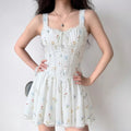 The dress styled on a model, highlighting its fitted corset silhouette, lace details, and ditsy floral print.