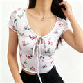 Studio model front view white floral rose print keyhole tie front short sleeve crop top