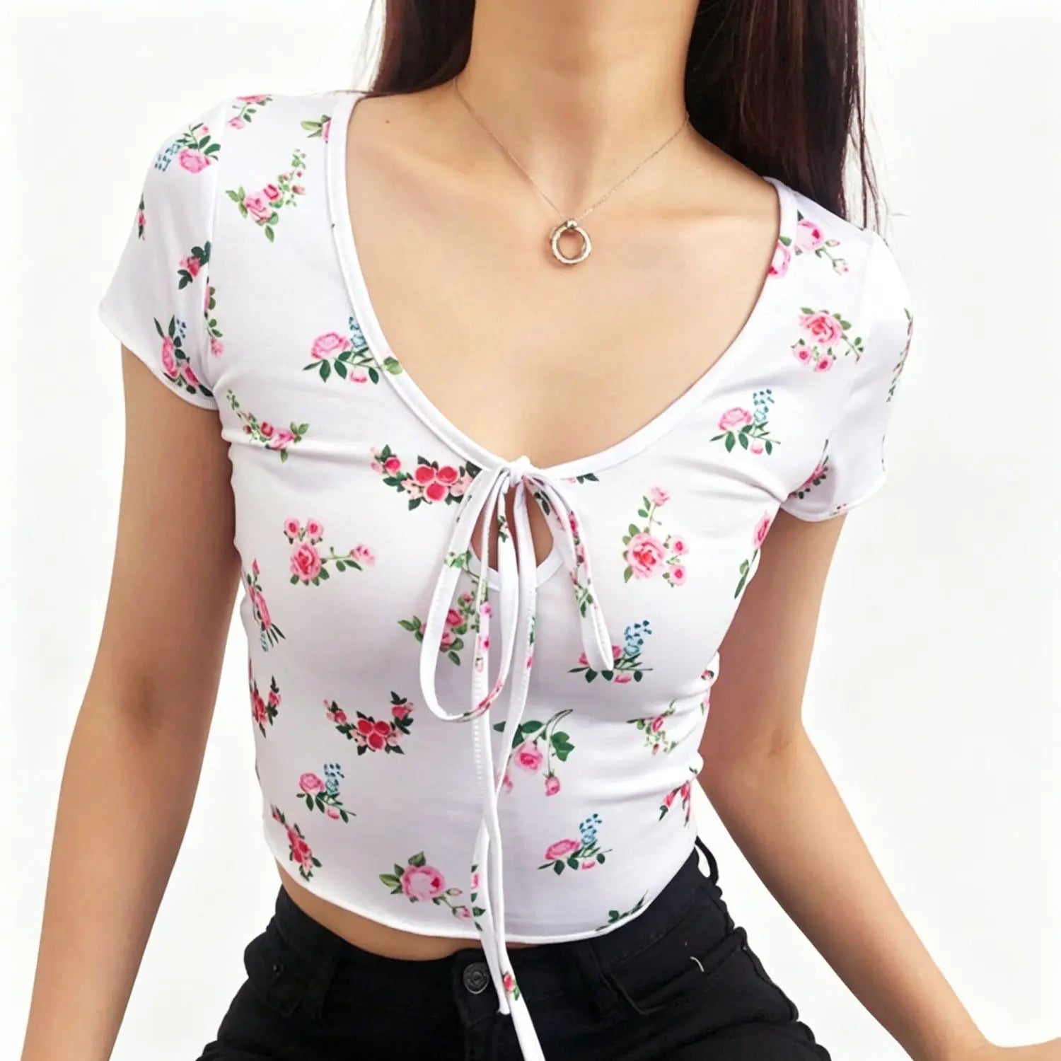 Studio model front shot wearing white short sleeve rose floral tie‑front keyhole crop top