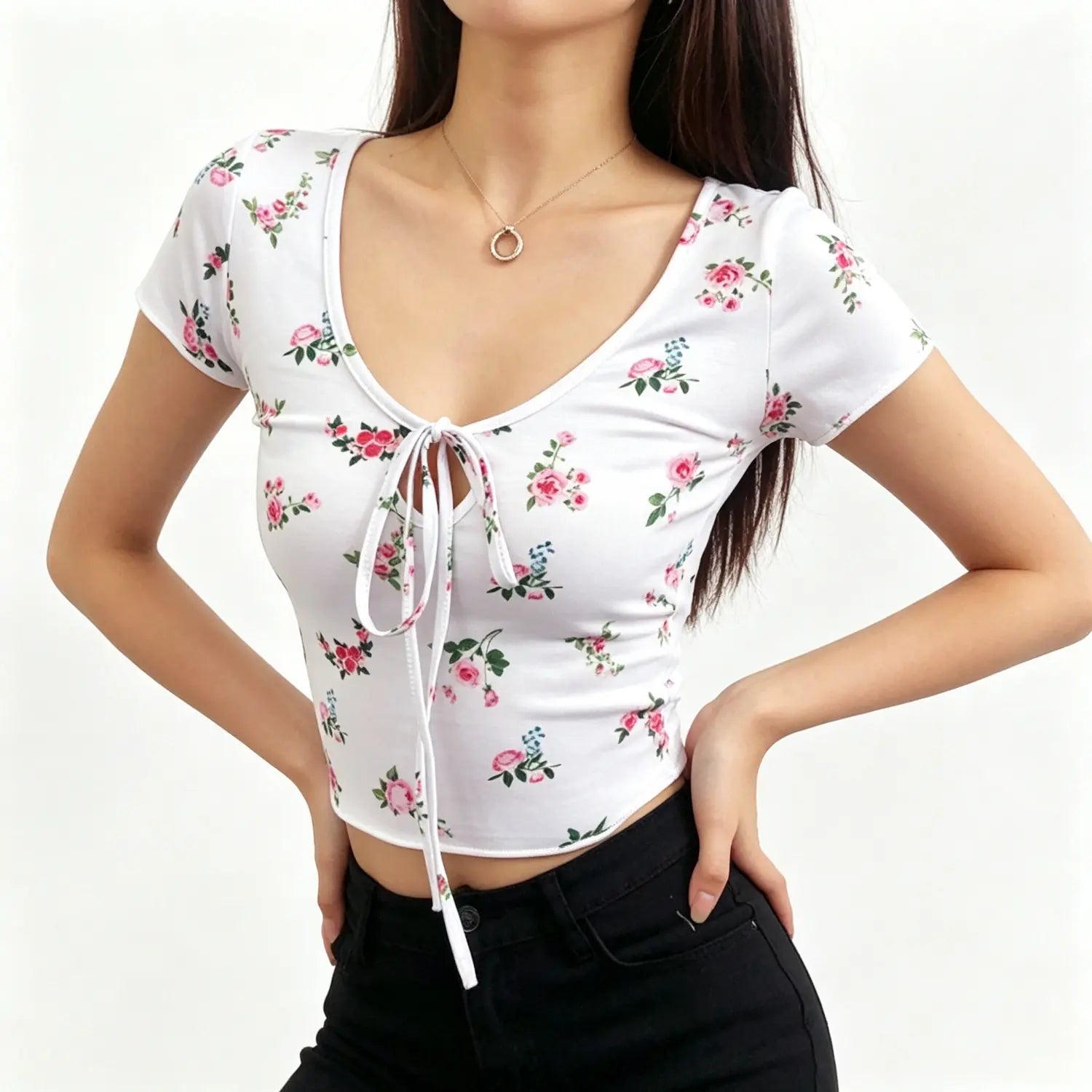 Studio model pose hands on hip in white rose print tie‑front short sleeve cropped top