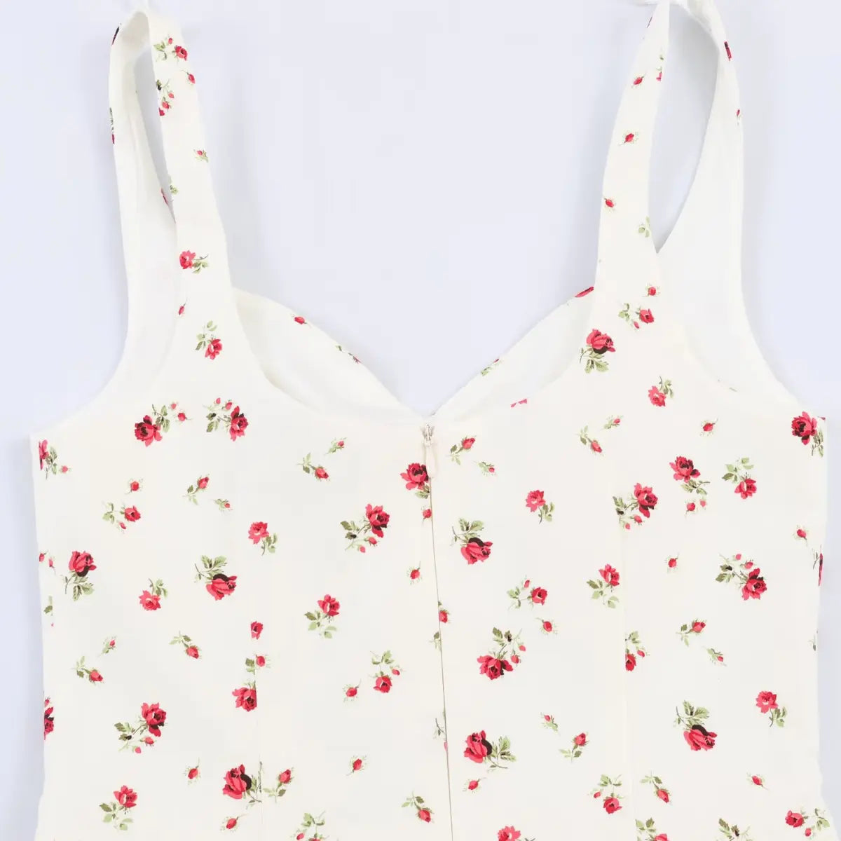 Back view of the dress's bodice, showing the center zipper and floral print.