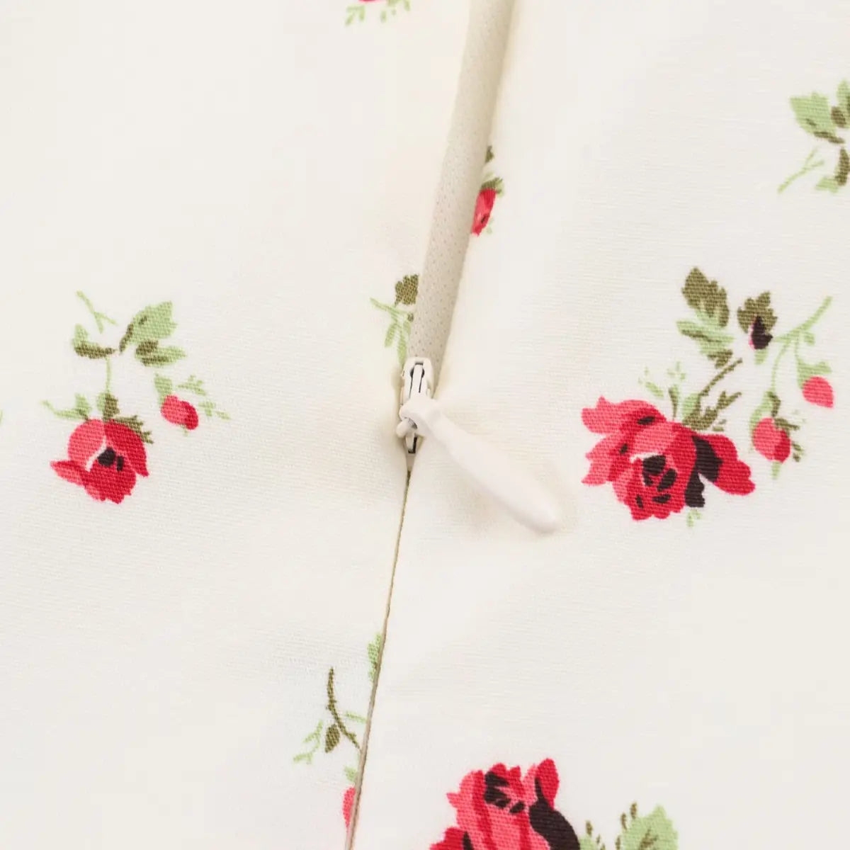 Close-up of the dress's hidden back zipper, with a matching white pull tab.
