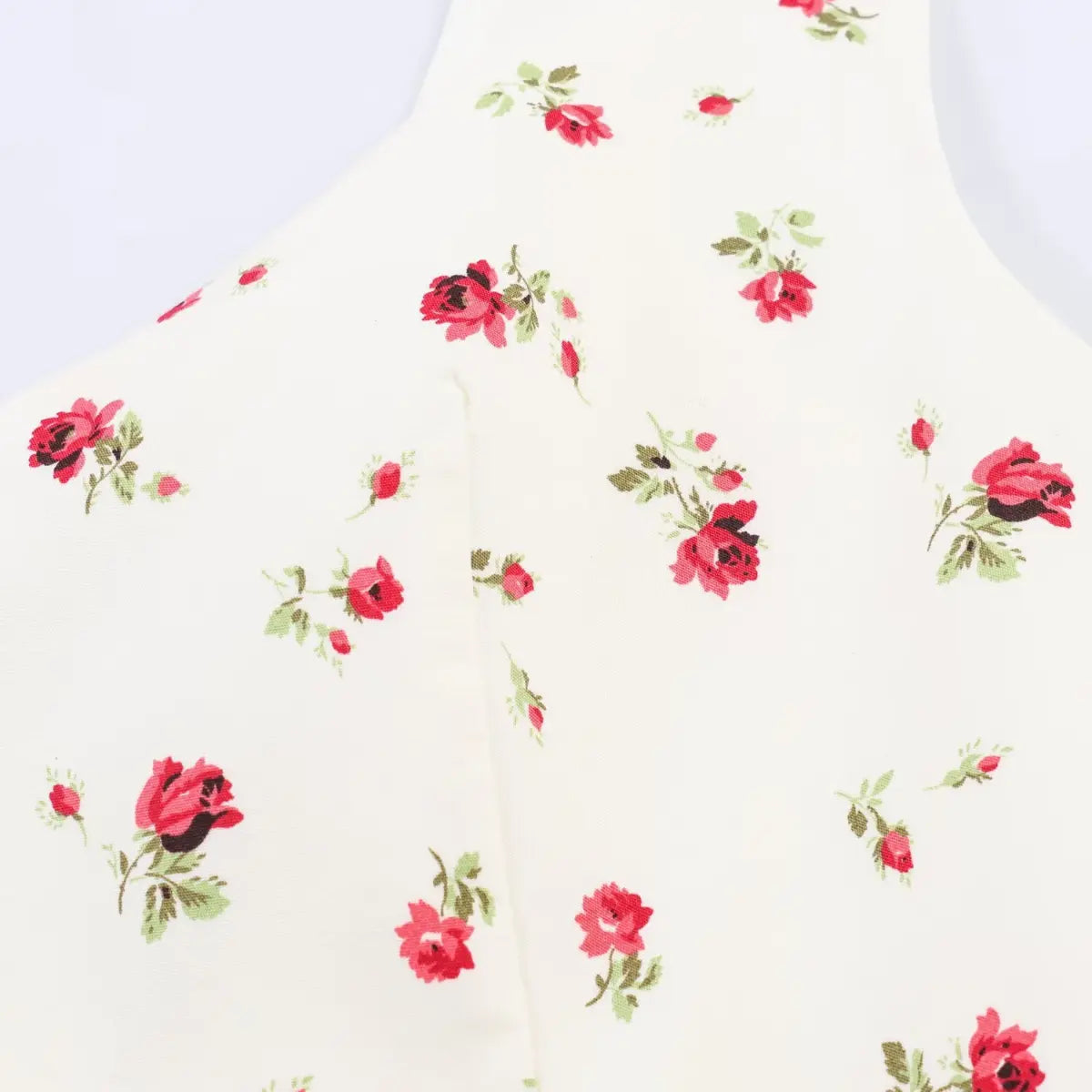 Close-up of the dress's fitted bodice, highlighting the delicate red rose pattern and center seam.