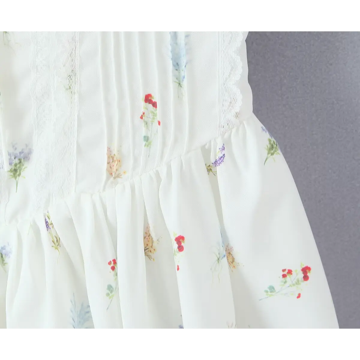Close-up of the dress's corset-style bodice and gathered skirt, with lace panels.
