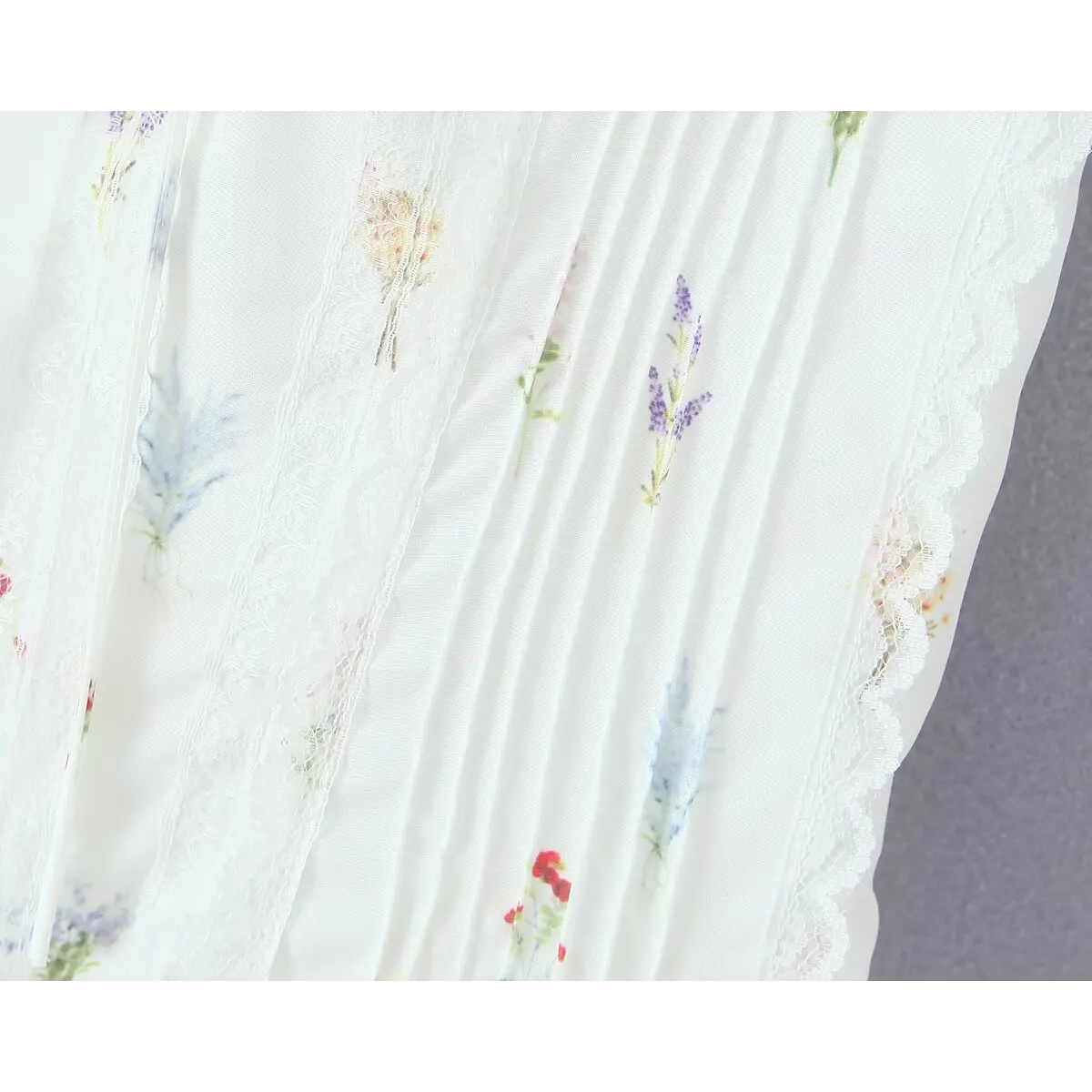 Close-up of the dress's corset-style bodice, showing lace panels and pintuck detailing.