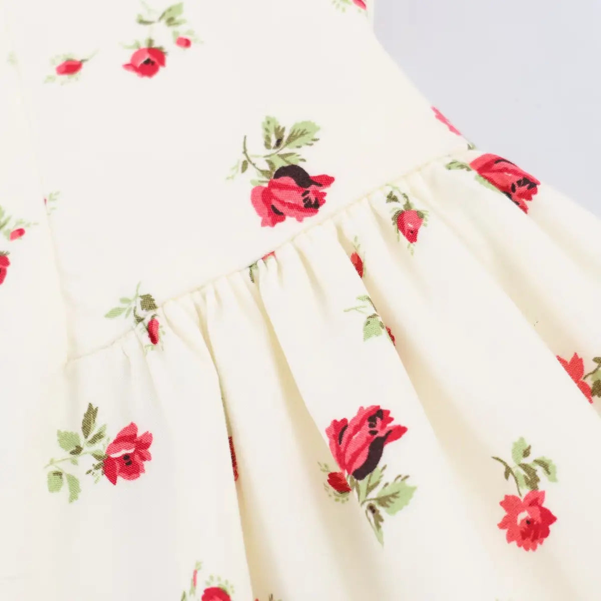 Close-up of the dress's waist seam, showing how the gathered skirt attaches to the fitted bodice.