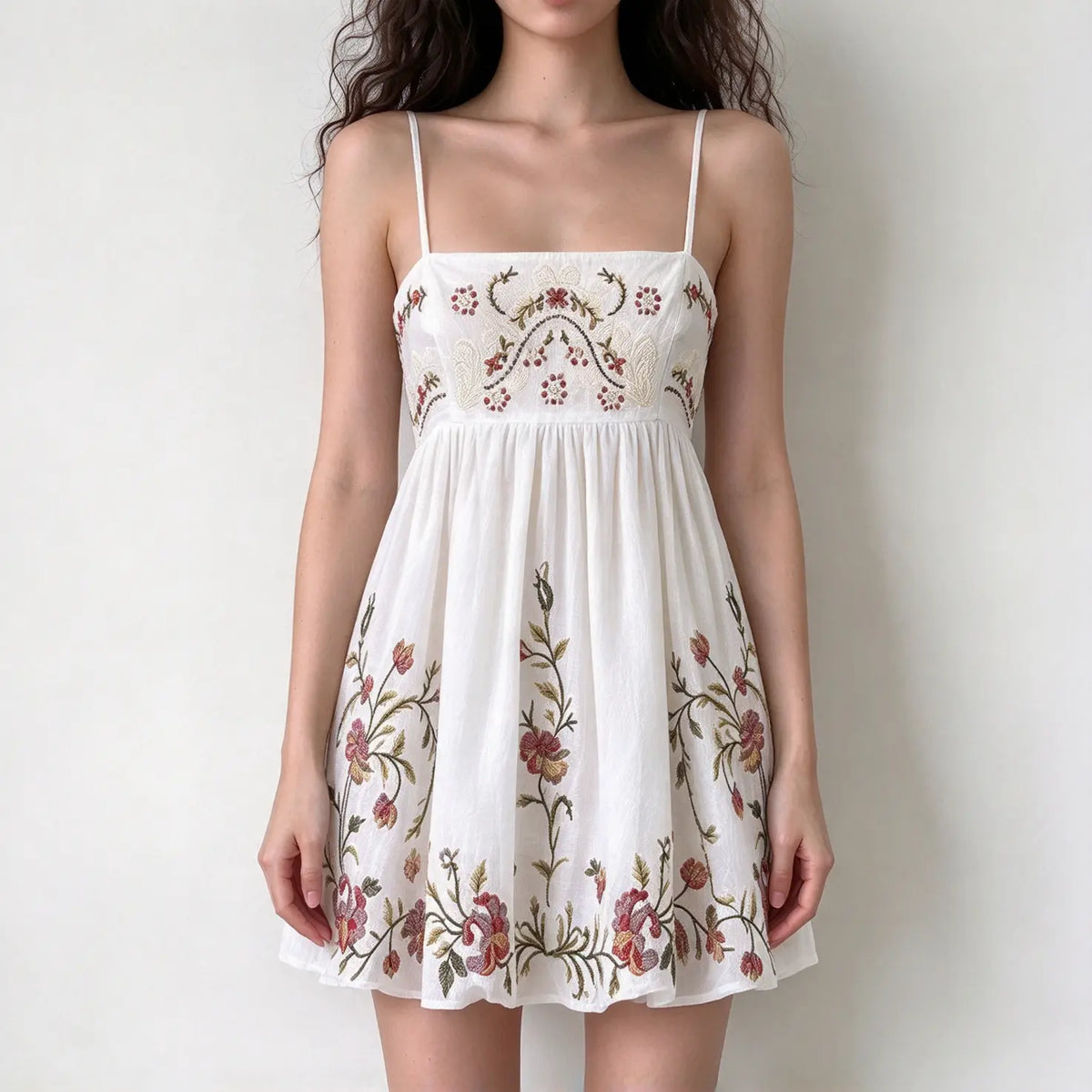 White spaghetti strap mini dress with allover colorful floral embroidery, flowy babydoll silhouette
