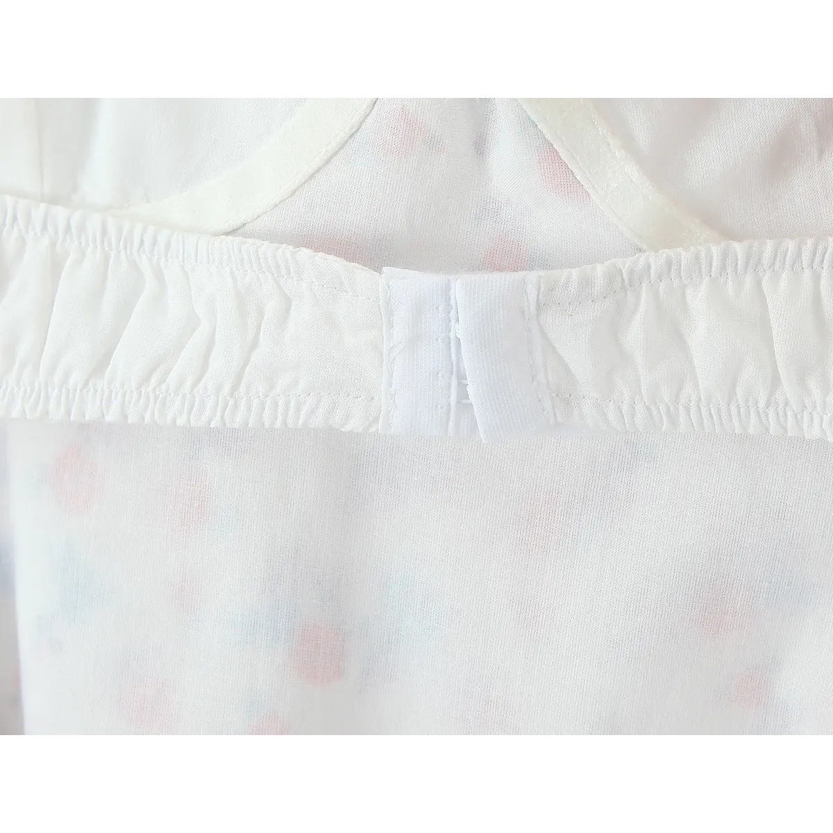 Close-up of the gathered elastic back panel and hook-and-eye closure on the floral slip dress