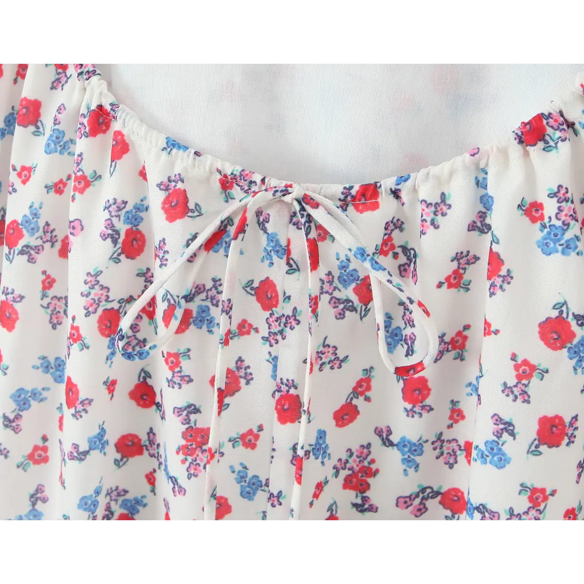 Close-up of the adjustable drawstring tie detail on the open back waist of the floral slip dress