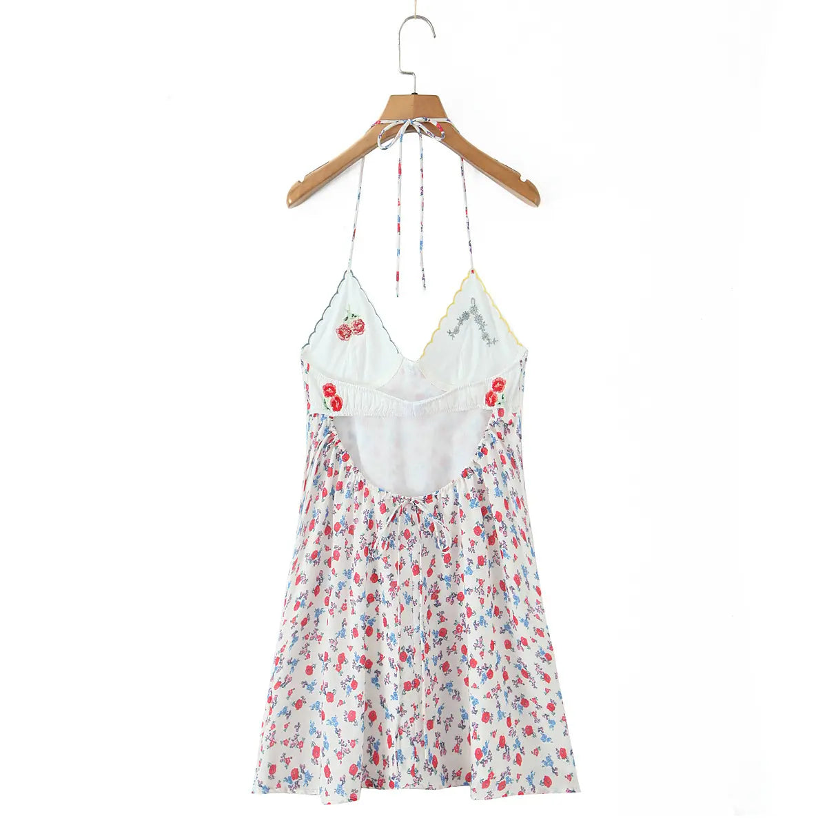 Full back view of the halter floral slip dress, showing open back, tie closure, and gathered waist tie detail