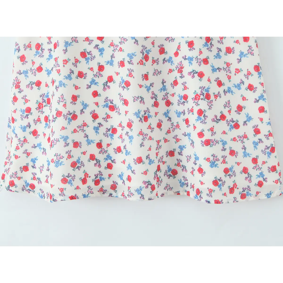 Close-up of the red and blue floral print pattern on the lightweight skirt hem