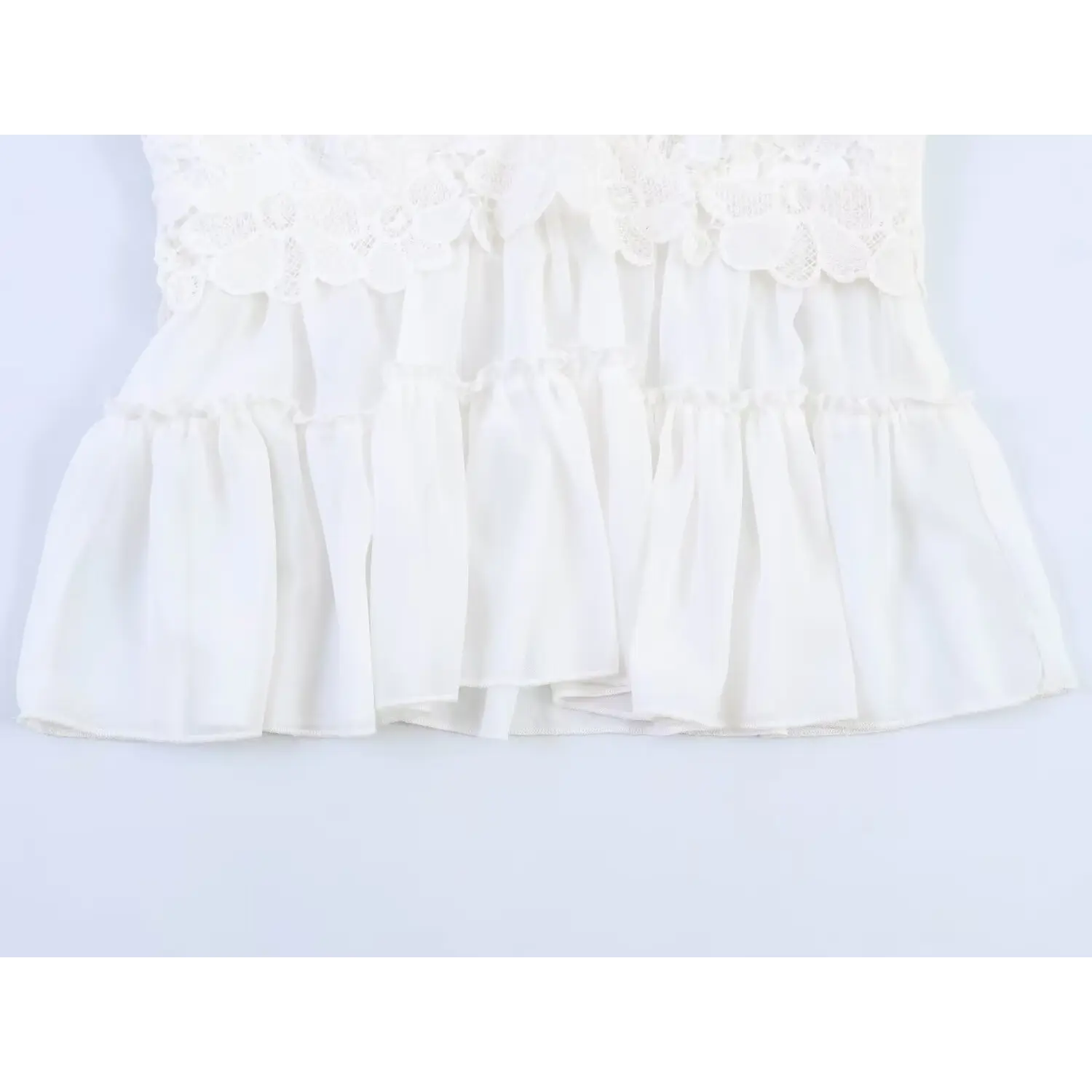 Close-up of two-tiered ruffle chiffon hem, soft lightweight fabric with neat overlock edging and gathered frill seam