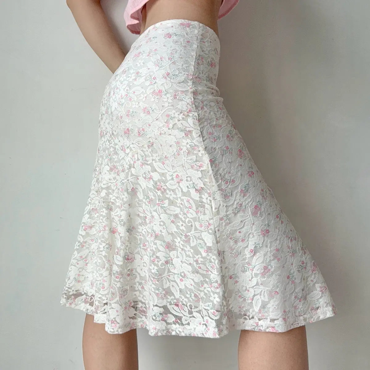 Side profile view of the white floral lace midi skirt, showing the silhouette.