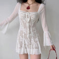 Model wearing white square neck long bell sleeve sheer floral lace mini dress front lifestyle shot