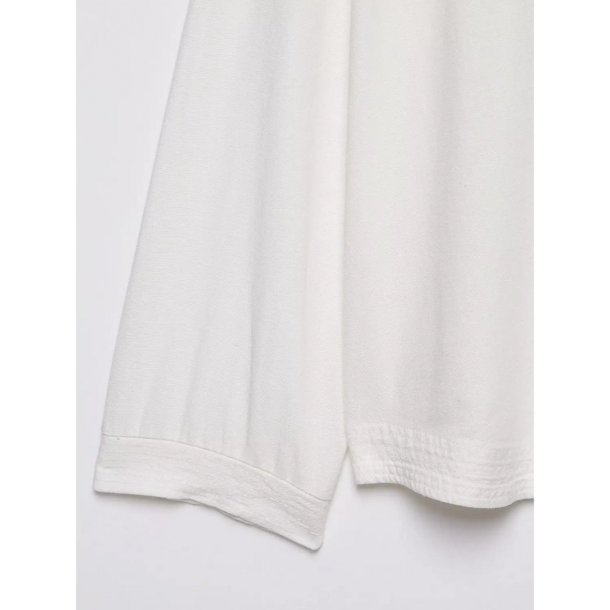Close-up of shirred hem band and side seam