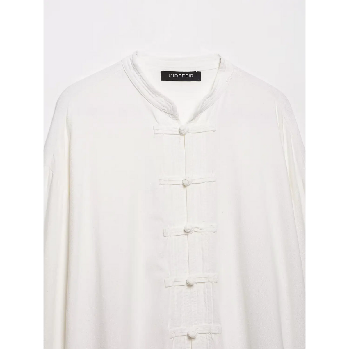 Close-up of collar, inner label and frog buttons