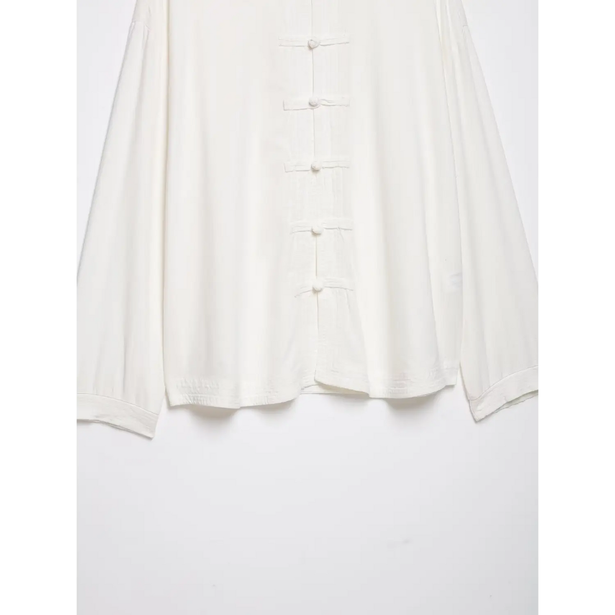 Close-up of frog button placket and shirred hem